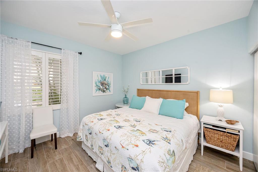 312 Bears Paw Trail Naples, FL 34105 - Photo 17 of 34 a bedroom with a large bed and a chair