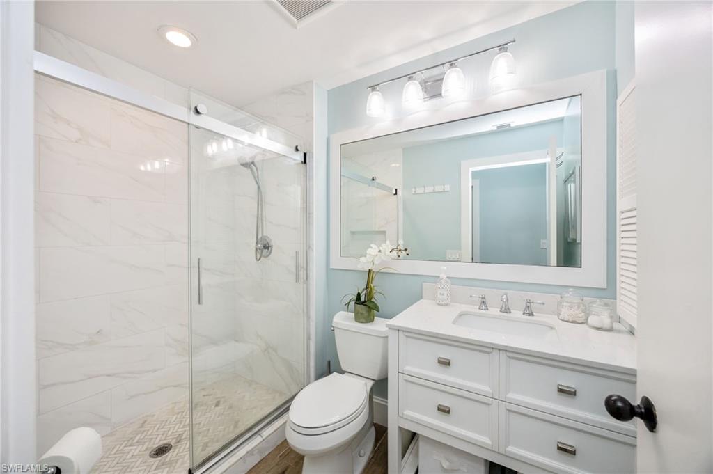 312 Bears Paw Trail Naples, FL 34105 - Photo 18 of 34 a bathroom with a sink vanity mirror and toilet