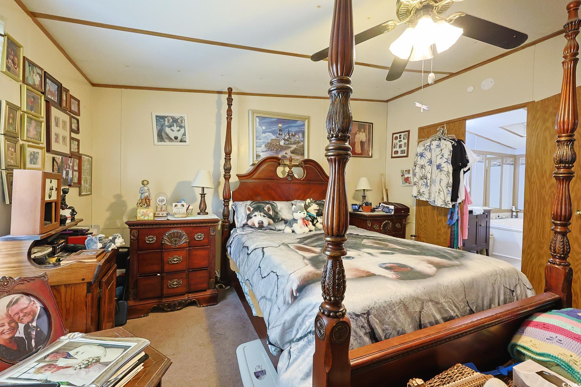 1522 Cove Lane Murrells Inlet, SC 29576 - Photo 11 of 33 Carpeted bedroom featuring ornamental molding and ceiling fan