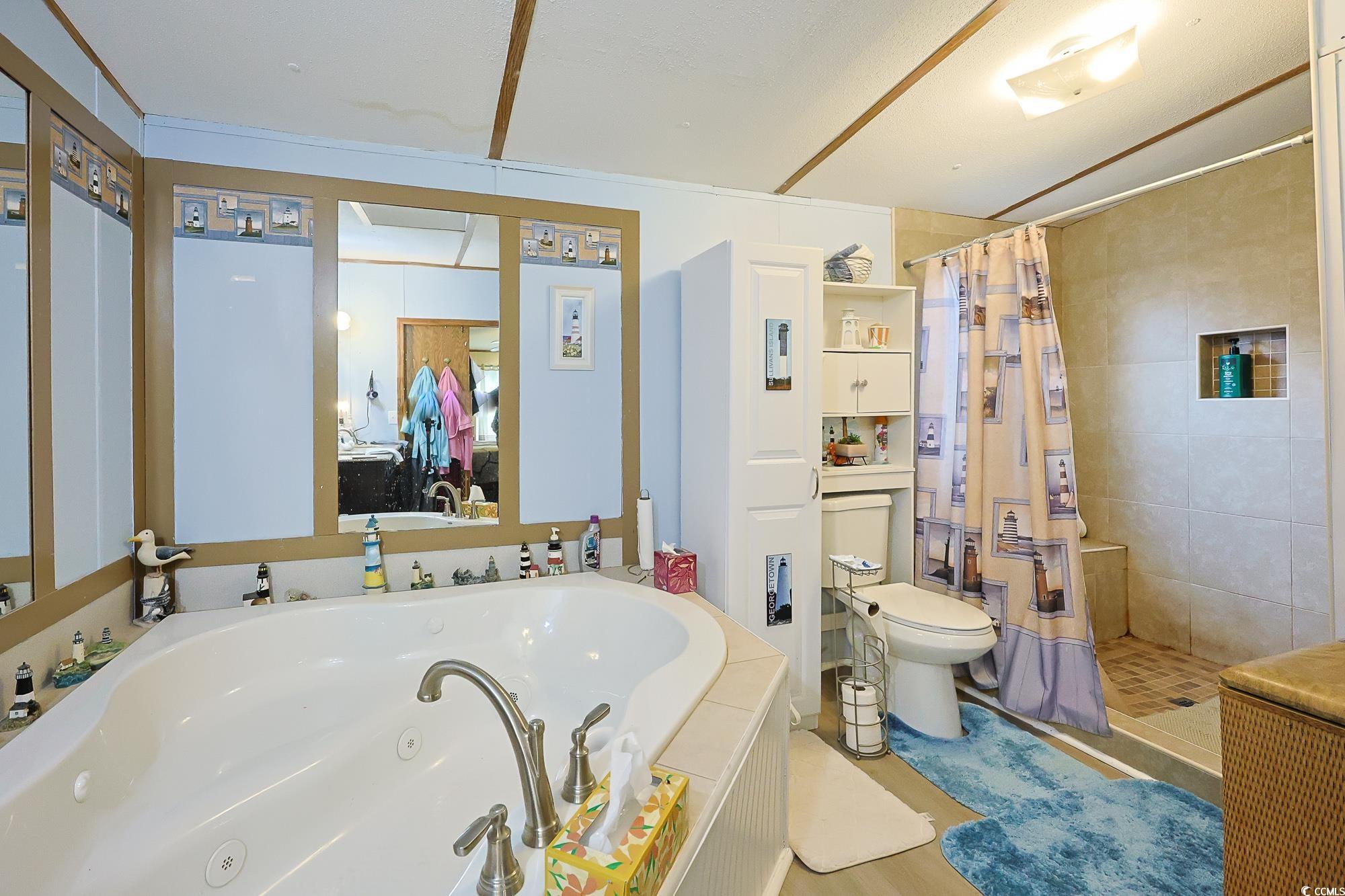 1522 Cove Lane Murrells Inlet, SC 29576 - Photo 15 of 33 Bathroom with a tub with jets, tiled shower, and connected bathroom
