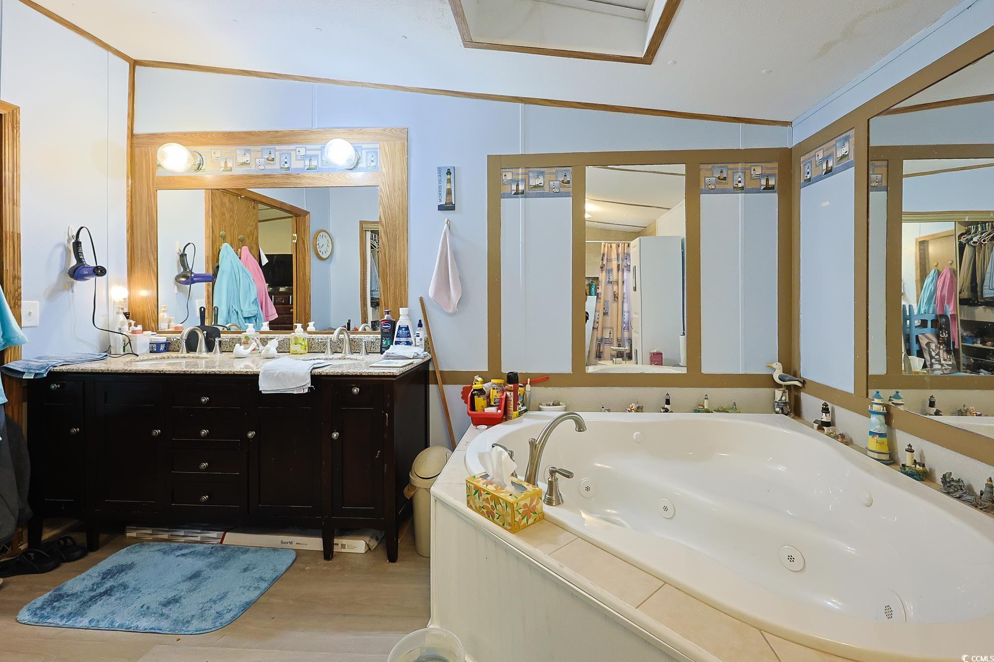 1522 Cove Lane Murrells Inlet, SC 29576 - Photo 16 of 33 Full bath with a jetted tub, vanity, light wood-style flooring, and crown molding