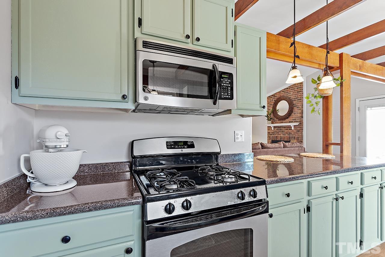 4520 Fox Road Raleigh, NC 27616 - Photo 8 of 20 a kitchen with stainless steel appliances granite countertop a stove and a microwave
