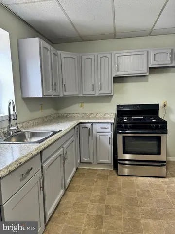 a kitchen with cabinets appliances and a sink