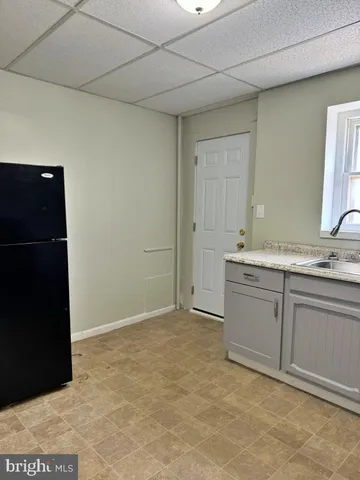 a bathroom with a granite countertop sink and mirror