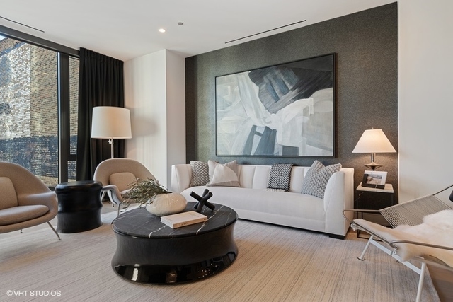 1550 North Clark Street, Unit 302 Chicago, IL 60610 - Photo 2 of 23 a living room with furniture and a lamp