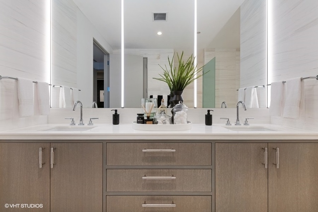 1550 North Clark Street, Unit 302 Chicago, IL 60610 - Photo 15 of 23 a bathroom with a sink and a mirror