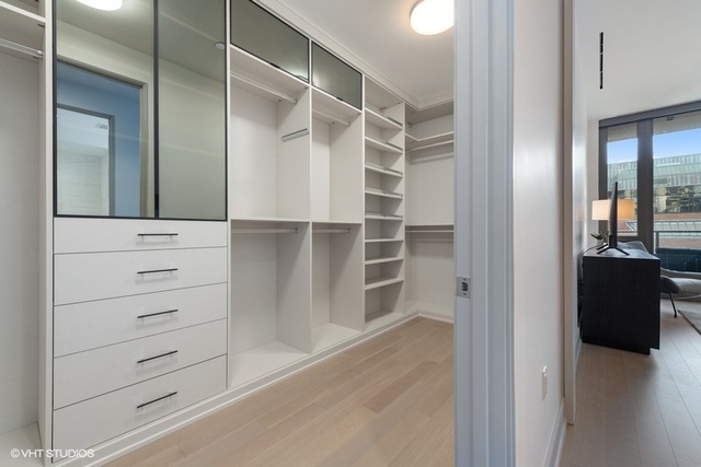 1550 North Clark Street, Unit 302 Chicago, IL 60610 - Photo 17 of 23 a view of walk in closet with empty racks