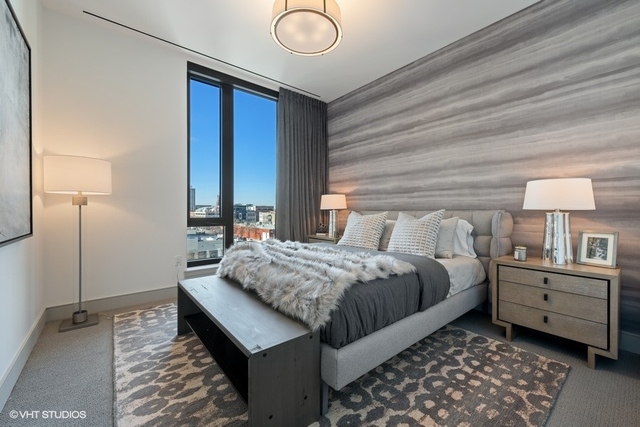 1550 North Clark Street, Unit 302 Chicago, IL 60610 - Photo 18 of 23 a bedroom with a bed and a window