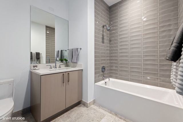 1550 North Clark Street, Unit 302 Chicago, IL 60610 - Photo 20 of 23 a bathroom with a bathtub and sink