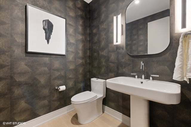 1550 North Clark Street, Unit 302 Chicago, IL 60610 - Photo 21 of 23 a bathroom with a toilet sink and mirror