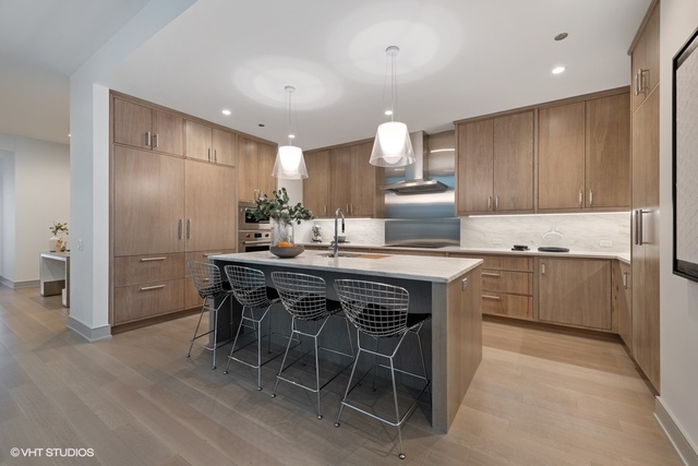 1550 North Clark Street, Unit 302 Chicago, IL 60610 - Photo 4 of 23 a kitchen with granite countertop a sink cabinets and stainless steel appliances