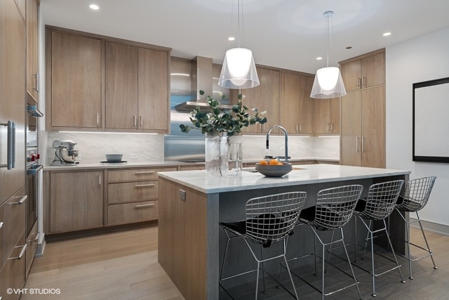 1550 North Clark Street, Unit 302 Chicago, IL 60610 - Photo 5 of 23 a kitchen with a table and chairs in it