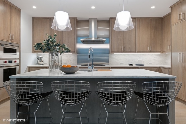 1550 North Clark Street, Unit 302 Chicago, IL 60610 - Photo 6 of 23 a kitchen with a table and chairs in it