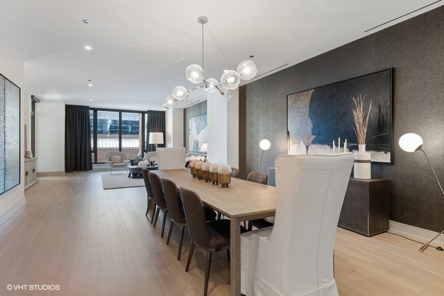 1550 North Clark Street, Unit 302 Chicago, IL 60610 - Photo 7 of 23 a view of a dining room with furniture and wooden floor
