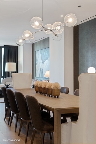 1550 North Clark Street, Unit 302 Chicago, IL 60610 - Photo 8 of 23 a view of a dining room with furniture and chandelier