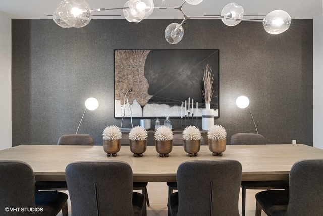 1550 North Clark Street, Unit 302 Chicago, IL 60610 - Photo 9 of 23 a dining room with furniture and chandelier