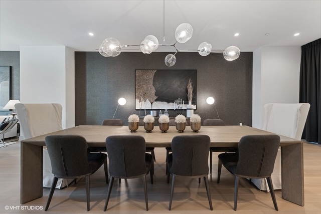 1550 North Clark Street, Unit 302 Chicago, IL 60610 - Photo 10 of 23 a view of a dining room with furniture and chandelier