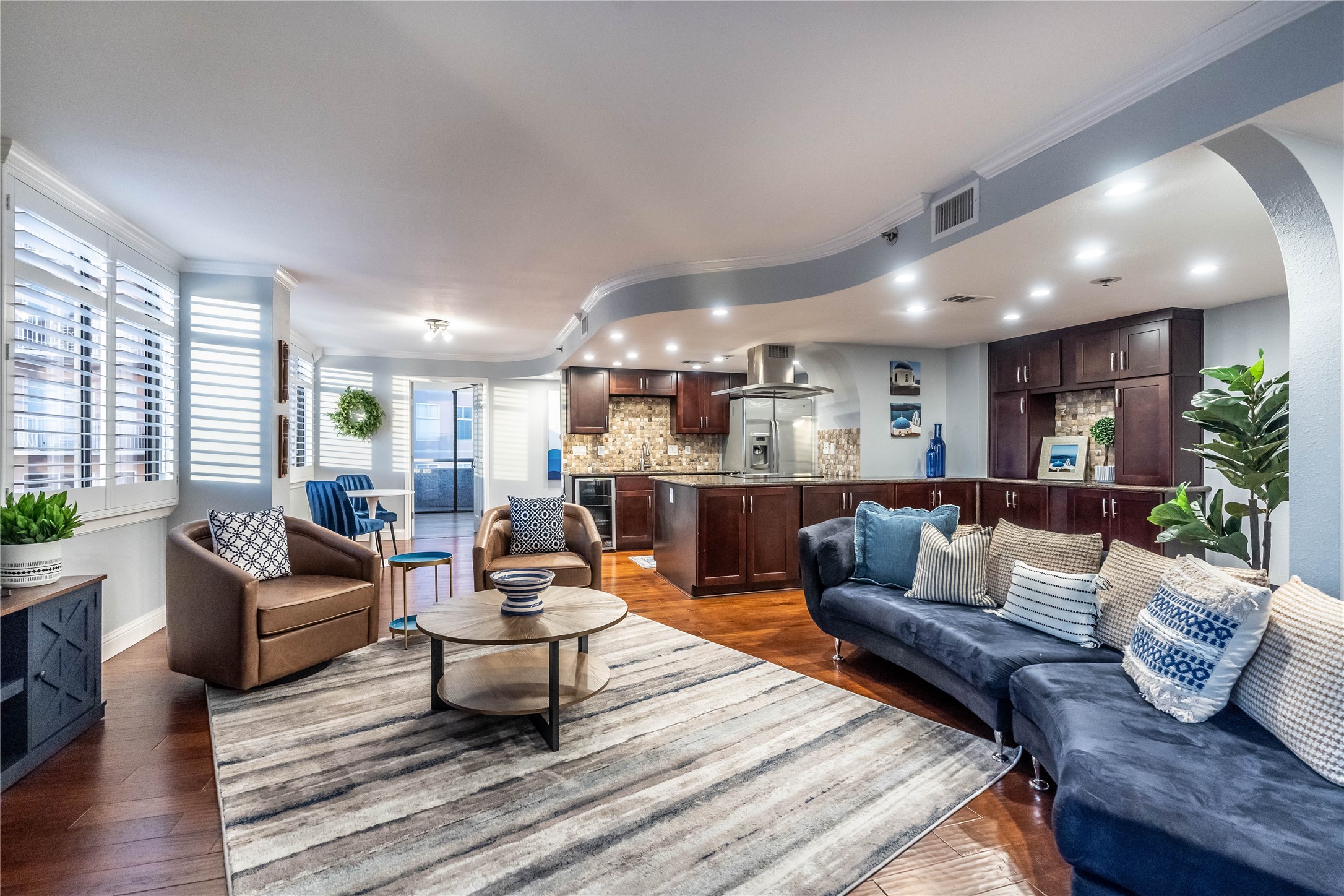 a living room with furniture and kitchen view