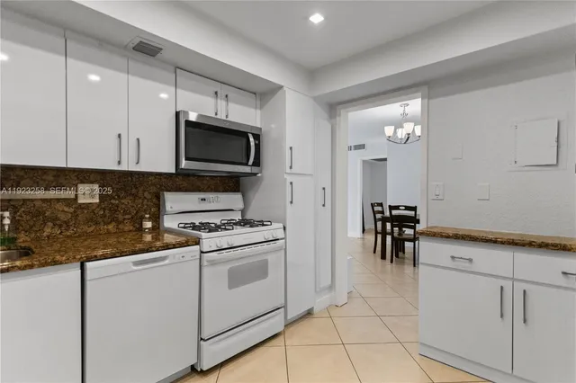a kitchen with cabinets and appliances