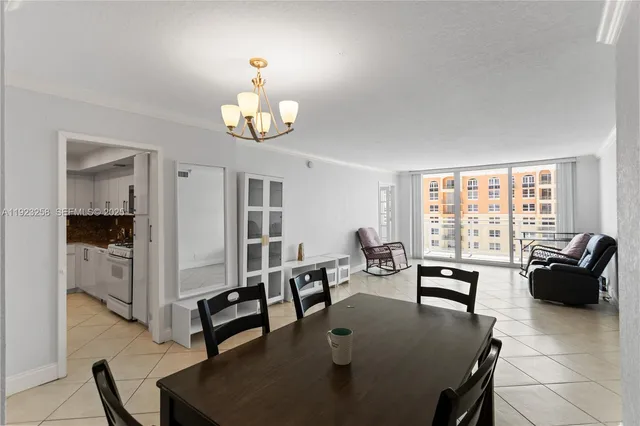 a living room with furniture chandelier and a table