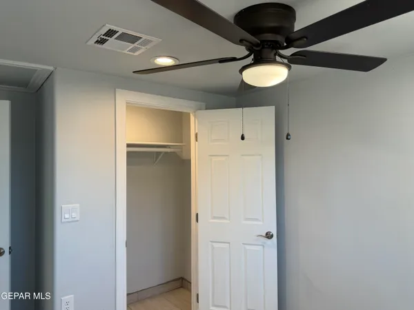 a view of a room that has a bed and a chandelier