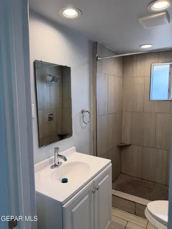 a bathroom with a sink toilet and shower