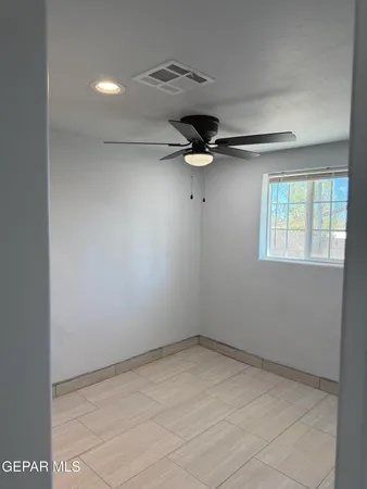 a view of room with a ceiling fan and window
