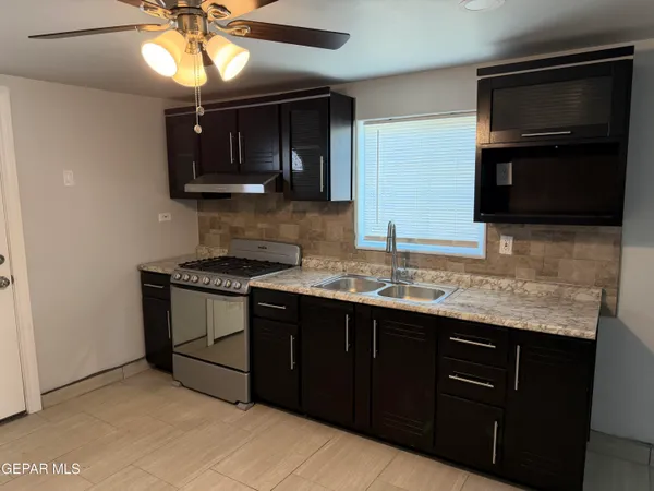 a kitchen with stainless steel appliances granite countertop a sink and cabinets