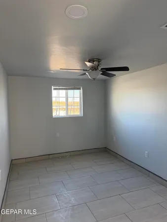 an empty room with a empty space and windows