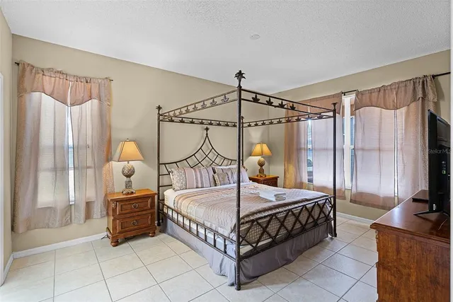 a bedroom with bed and a chandelier