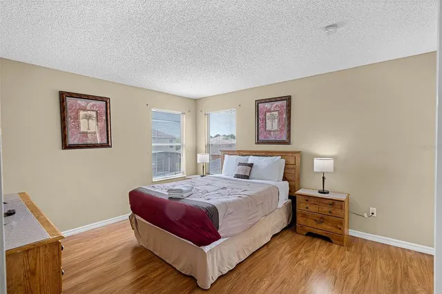 a spacious bathroom with a granite countertop sink a toilet and a mirror