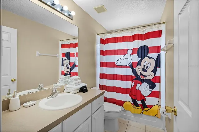 a bedroom with a bed and flat screen tv