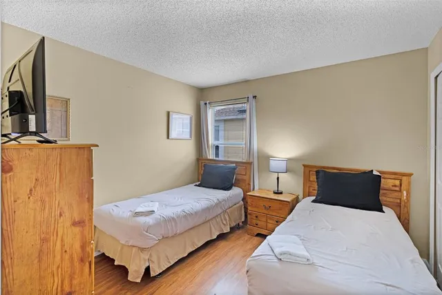 a bedroom with a bed and a night stand