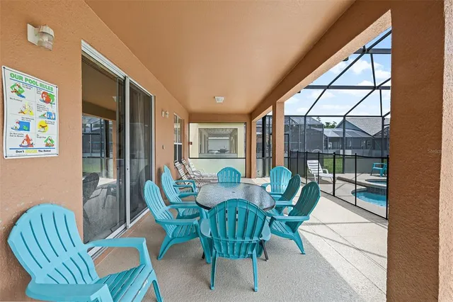 a view of a backyard with swimming pool
