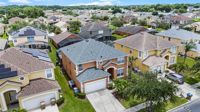 an aerial view of a house with a yard and furniture