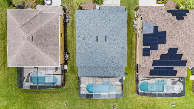 a view of a swimming pool with lawn chairs under an umbrella