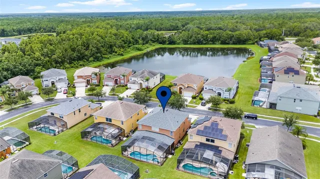 an aerial view of residential houses with outdoor space