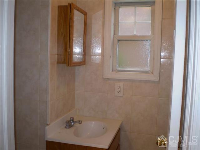 574 Scotland Road Orange, NJ 07050 - Photo 3 of 10 a bathroom with a sink and a window