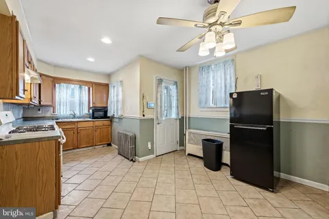 a kitchen with a refrigerator a sink dishwasher stove and oven