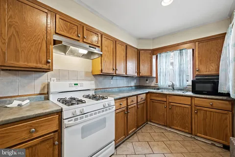 a kitchen with cabinets appliances and a window