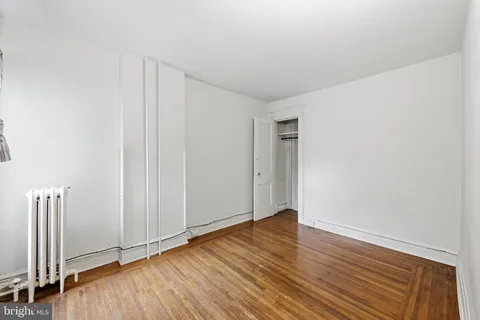 an empty room with wooden floor
