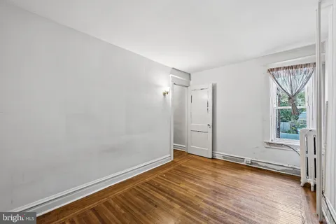 a view of room with window and wooden floor