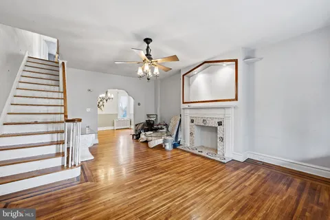 a living room with fireplace furniture and a wooden floor
