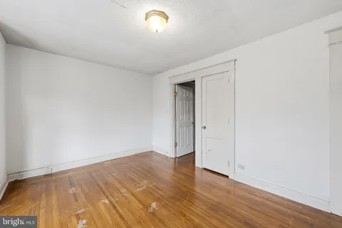 a view of an empty room and wooden floor