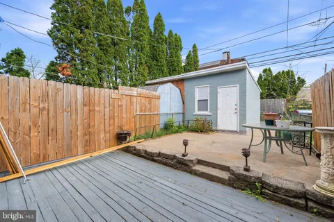 a view of a patio with table and chairs