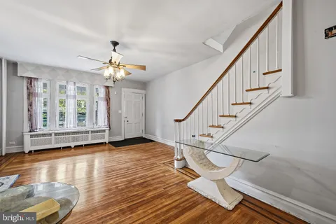 a view of entryway and hall with wooden floor