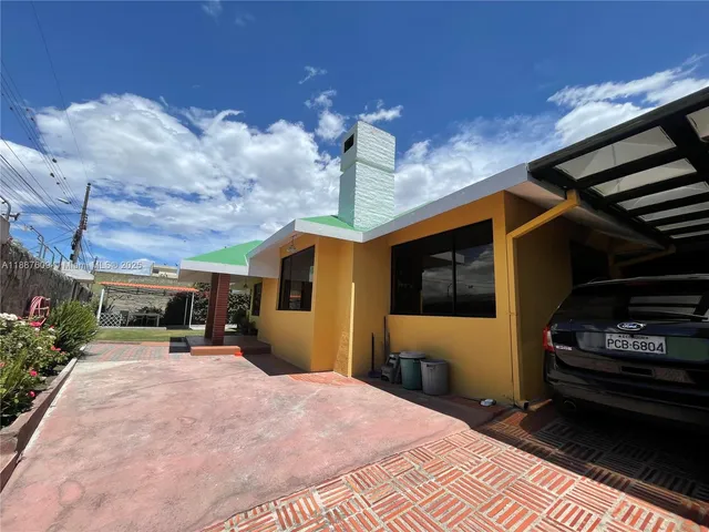 a bathroom with a granite countertop sink a mirror and shower