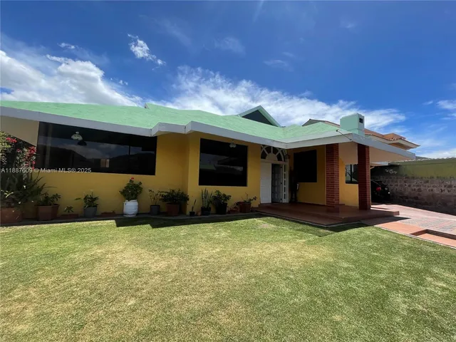 a view of a house with backyard porch and sitting area