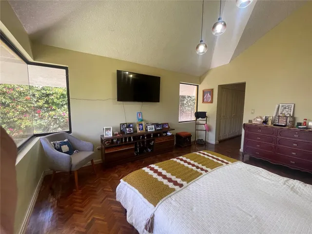 a bedroom with a bed and a large window