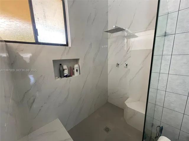 a living room with furniture city view and large windows